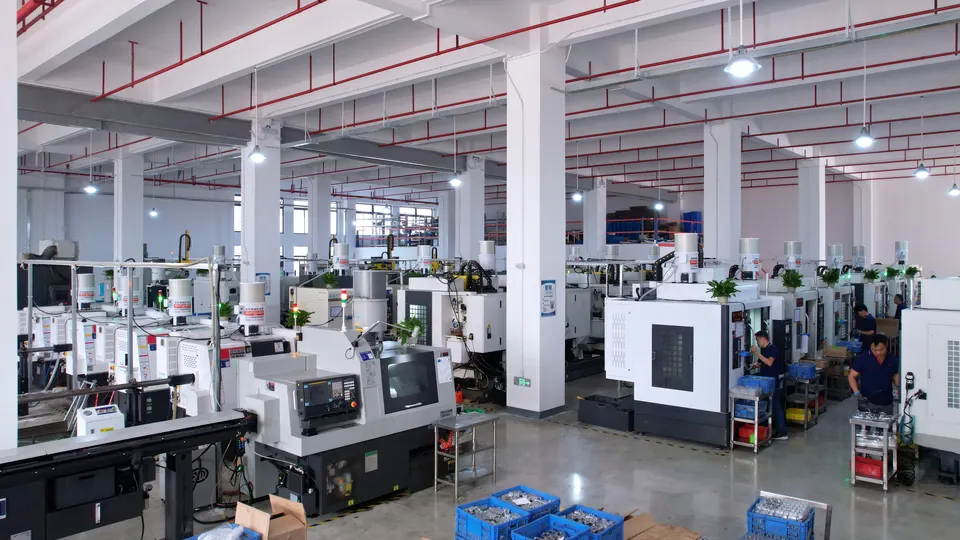 Wide view of a clean CNC machining workshop with multiple enclosed machines