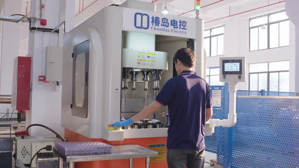 Operator standing at the control of a large enclosed machining center