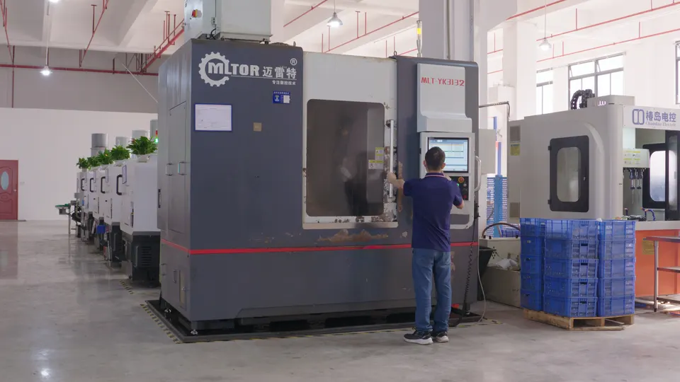 Operator using a vertical machining center on the factory floor